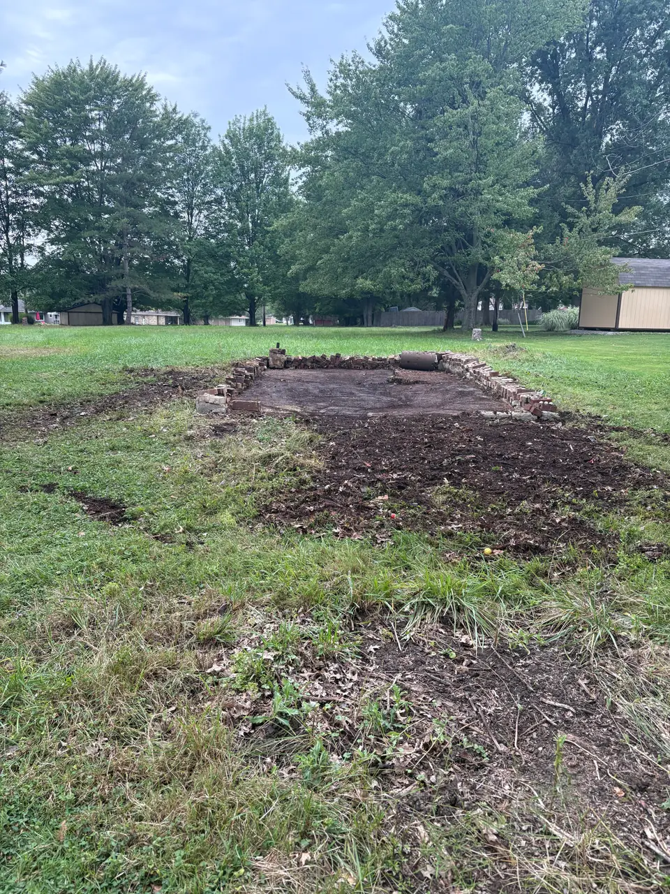 Broadview Heights site after garage demolition, with the existing base and perimeter bricks still visible.